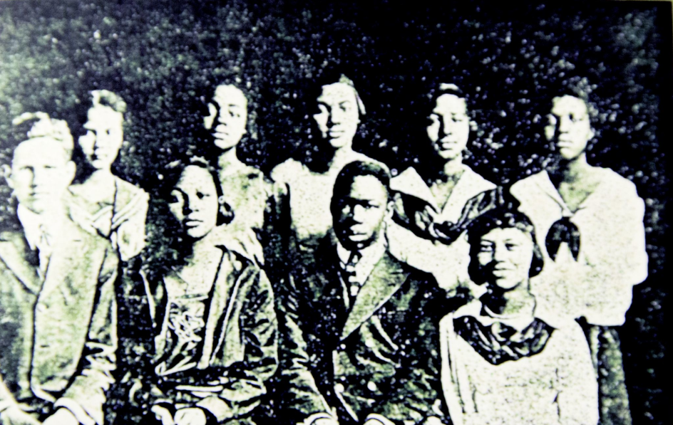 1921 Booker T. Washington Sophomore "A" Class, where Jones (seated, right) is listed as "James Jones," and next to his name a description reads, "I Can't Help it Because I am Tall." Dick Roland, it was reported, was 5'10". 